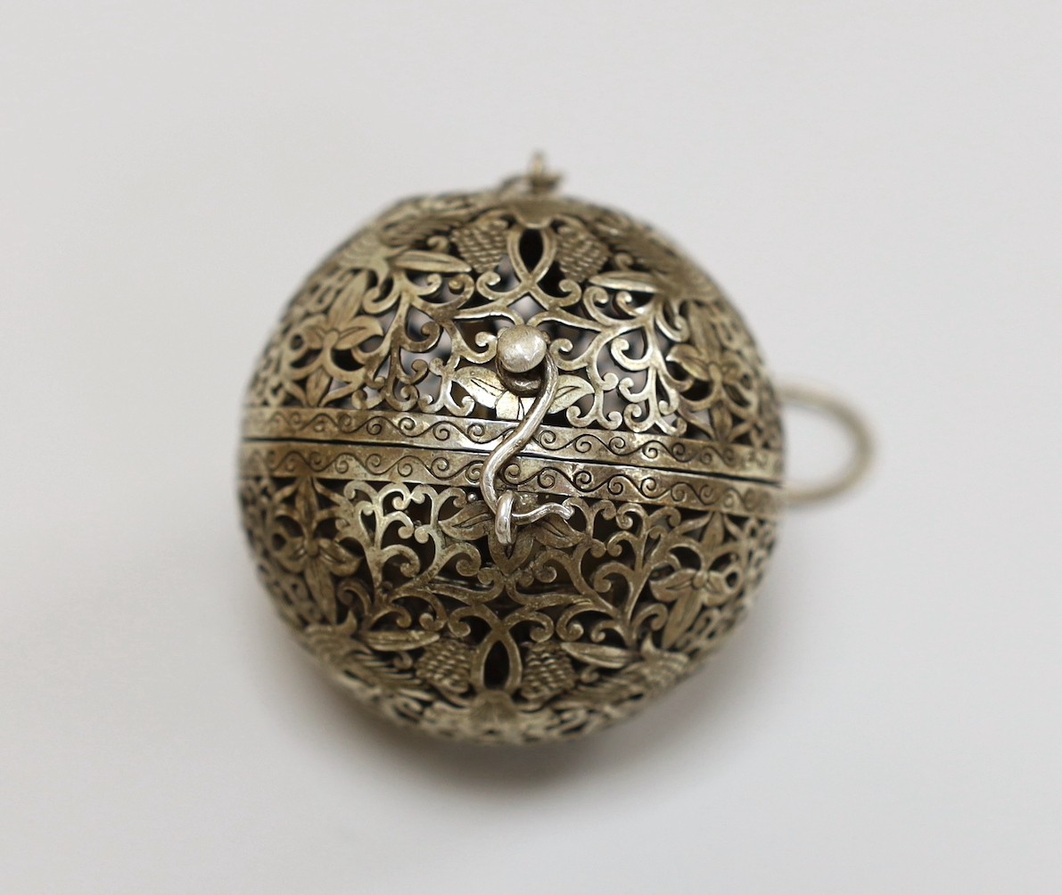 A Chinese spherical ornately worked metal perfume holder, 5.2cm